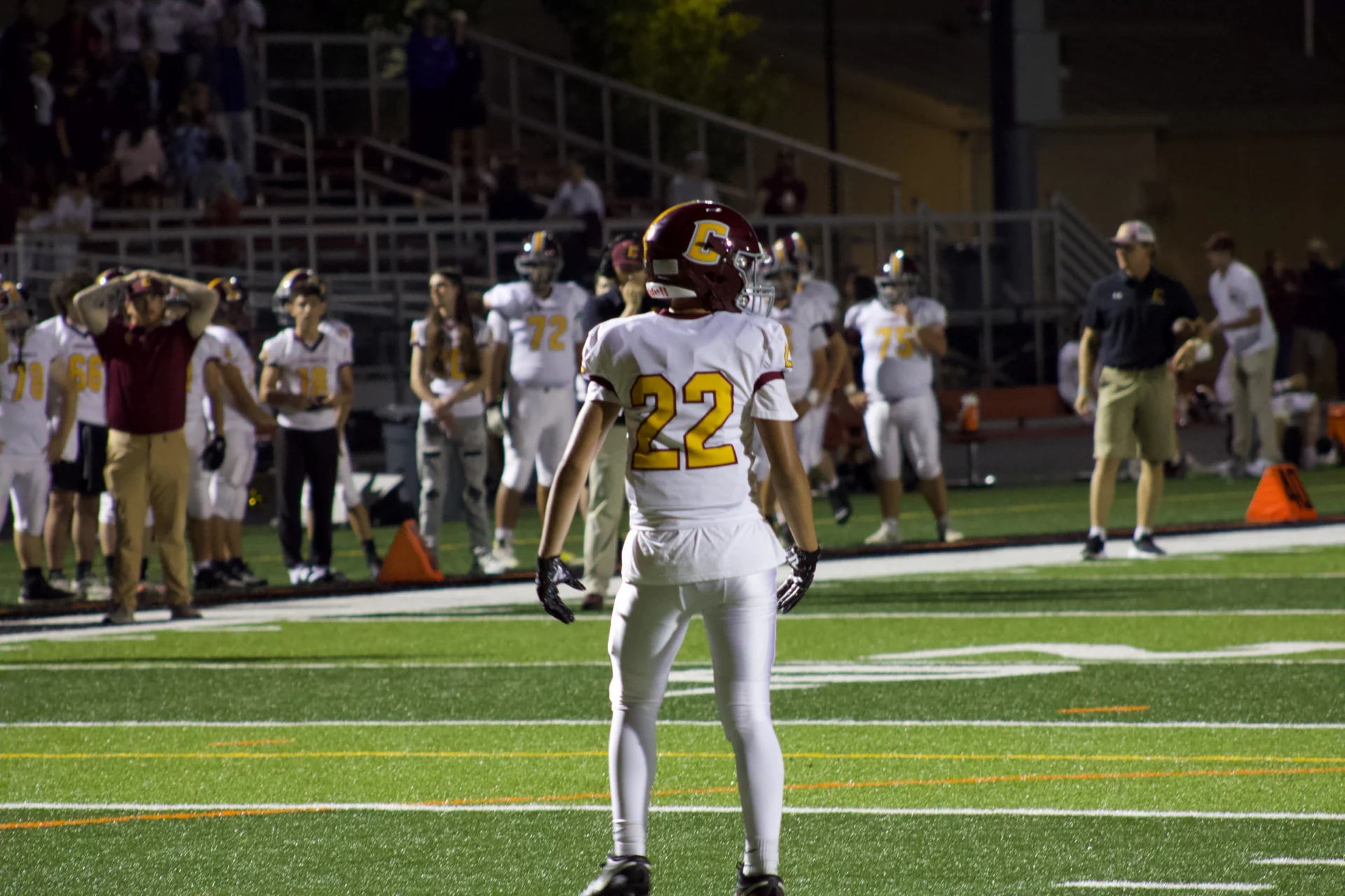 Logan Gadbois wearing number 22 on the football field at night